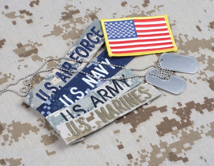 Uniform patches and identification plates from branches of the U.S. military.