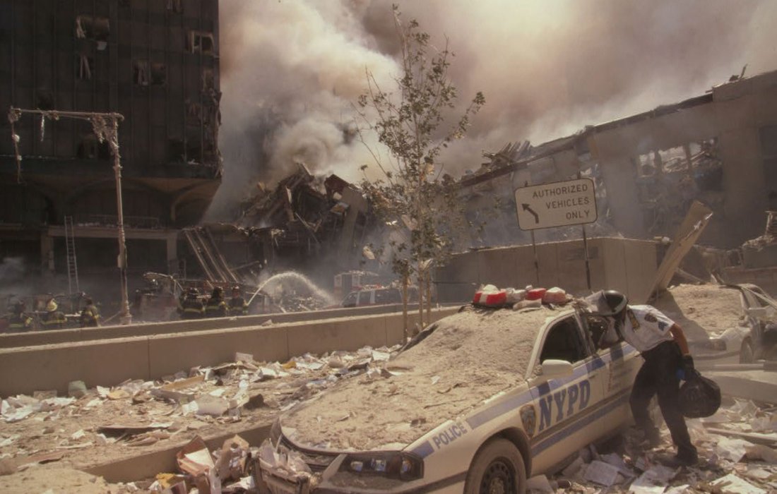 Rescue workers amid debris following September 11th terrorist attack on World Trade Center, New York City.