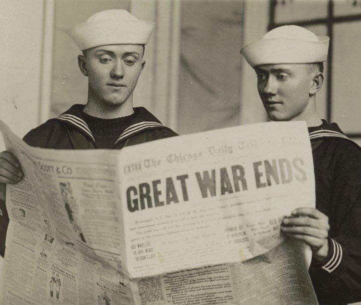 Two sailors read a newspaper with the headline “Great War Ends.” Courtesy of the Library of Congress.