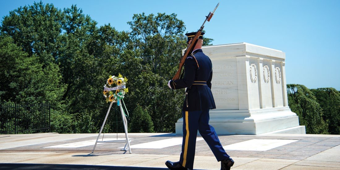 A member of the U.S. Army honor guard walks past the Tomb of the Unknown Soldier at Arlington National Cemetery.