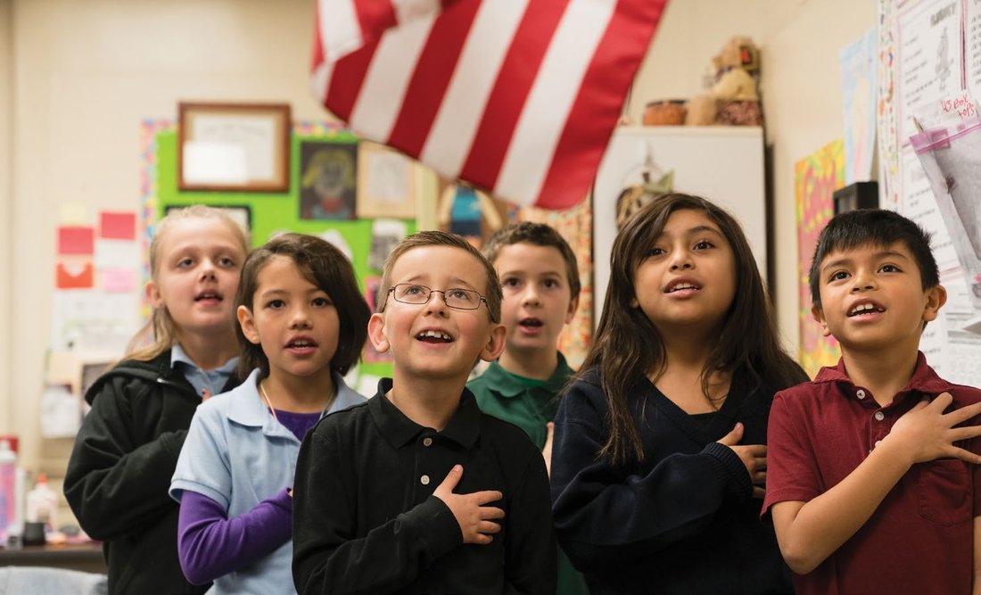Students recite the Pledge of Allegiance.